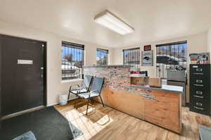 Entryway with light wood-style floors and a textured ceiling