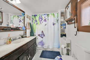 Full bathroom featuring vanity, shower / bath combination with curtain, and light marble finish flooring