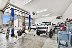 Garage featuring a heating unit and a workshop area