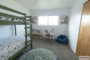 Bedroom with carpet flooring and baseboards