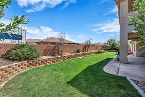 Fenced backyard with a patio
