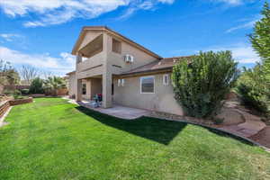 Rear view of property featuring stucco siding, a patio, and a balcony