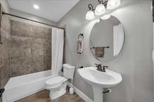 Bathroom with toilet and shower / bath combo with shower curtain
