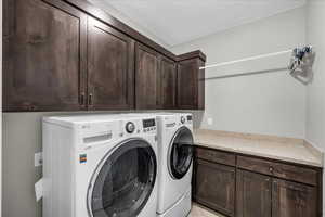Laundry room featuring washing machine and dryer and cabinet space
