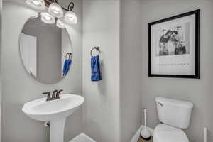 Bathroom featuring toilet and baseboards