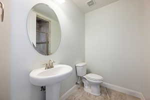 Bathroom with toilet and baseboards