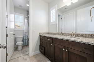 Bathroom with vanity and curtained shower
