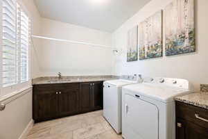 Laundry area with cabinet space and washing machine and dryer