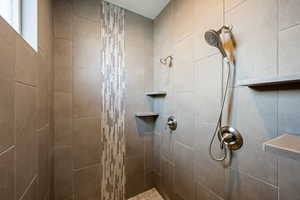 Bathroom featuring a tile shower