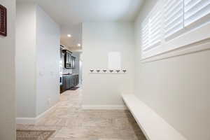 Corridor with baseboards and recessed lighting