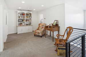 Sitting room featuring light colored carpet and recessed lighting