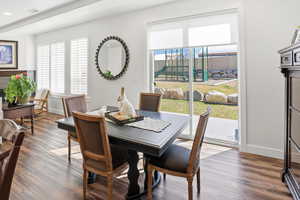 Dining room featuring dark wood finished floors and baseboards