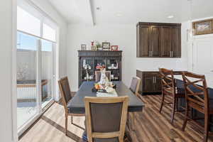 Dining room featuring dark wood-style floors, recessed lighting, and beamed ceiling