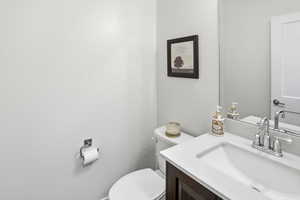 Half bathroom with toilet and vanity