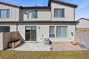 Back of property featuring board and batten siding and a patio area