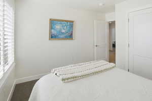 Bedroom with carpet flooring and baseboards