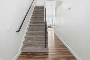 Staircase featuring wood finished floors