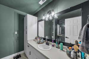 Bathroom featuring vanity and baseboards