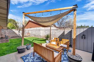 Fenced backyard with outdoor lounge area and a patio area