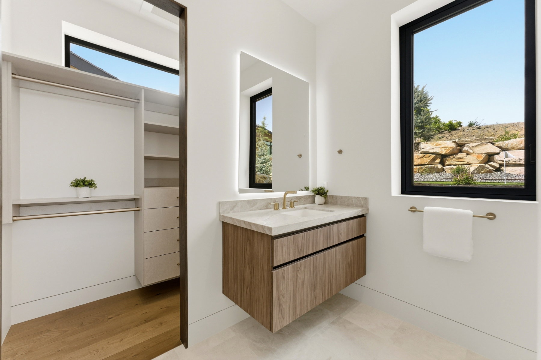 Floating vanity with a stone countertop and undermount sink