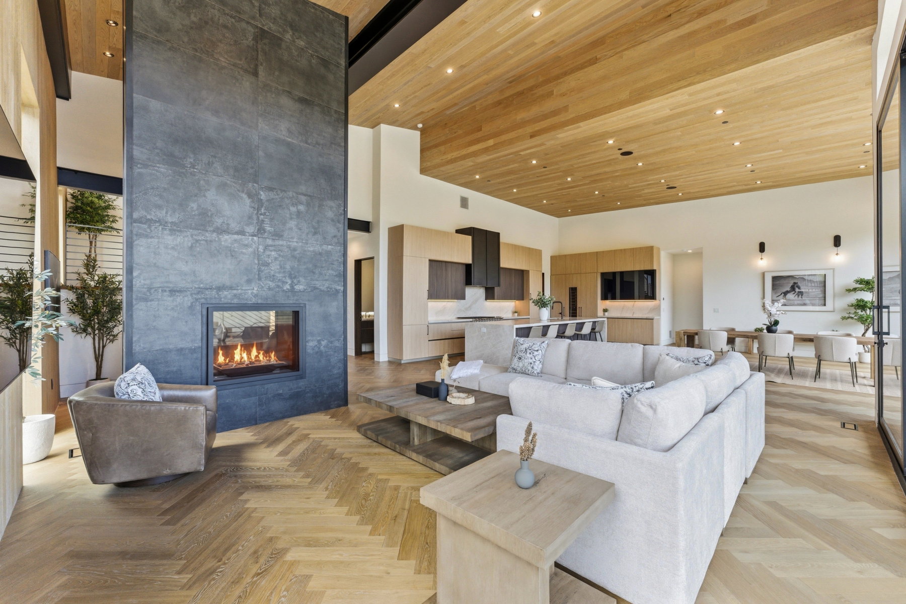 Expansive living space featuring a floor-to-ceiling stone fireplace