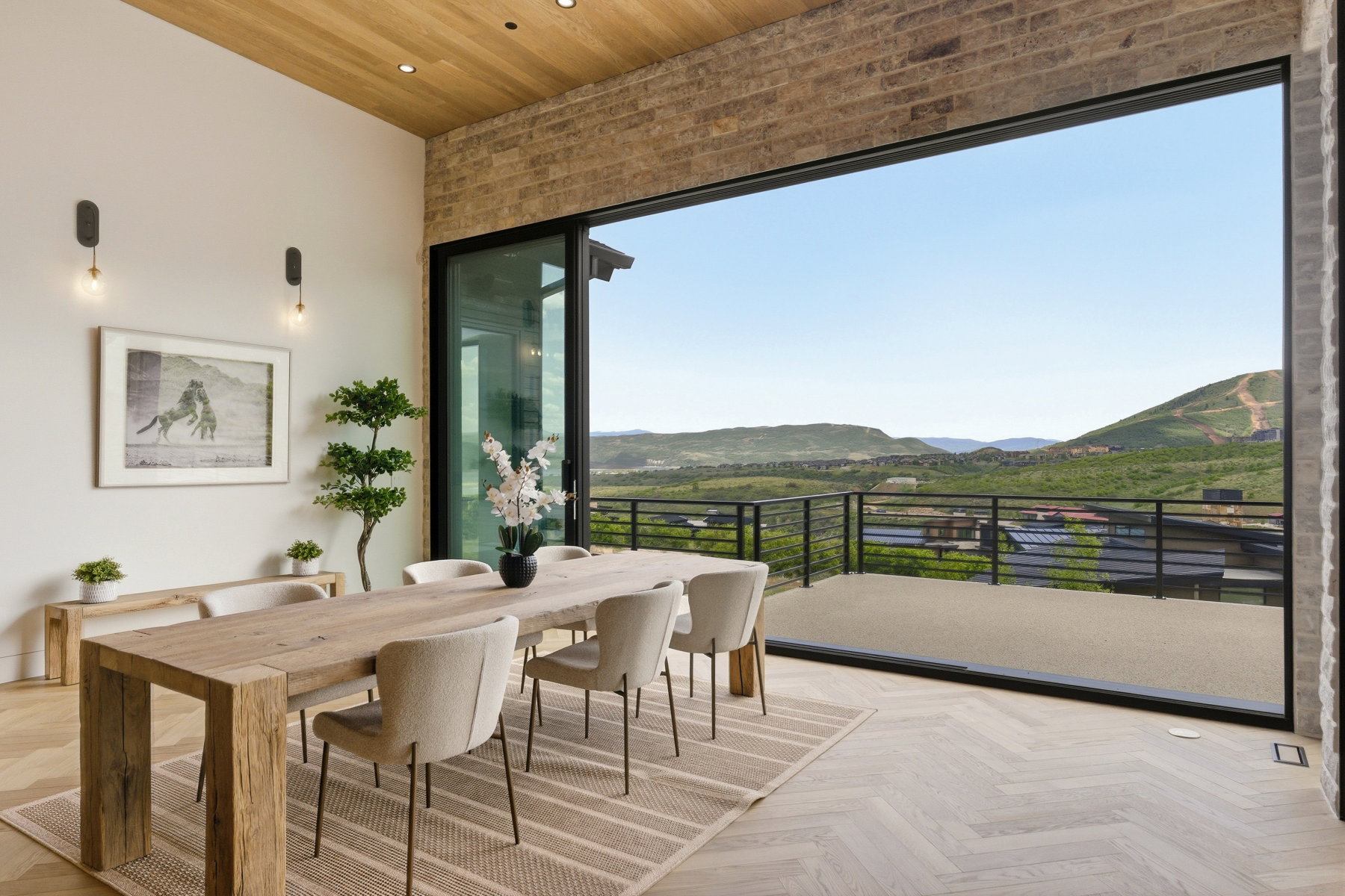 Expansive sliding glass doors opening to an outdoor deck with metal railings
