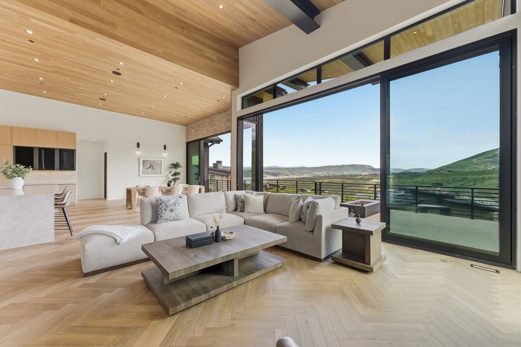 Expansive living area featuring a vaulted wood-paneled ceiling with recessed lighting