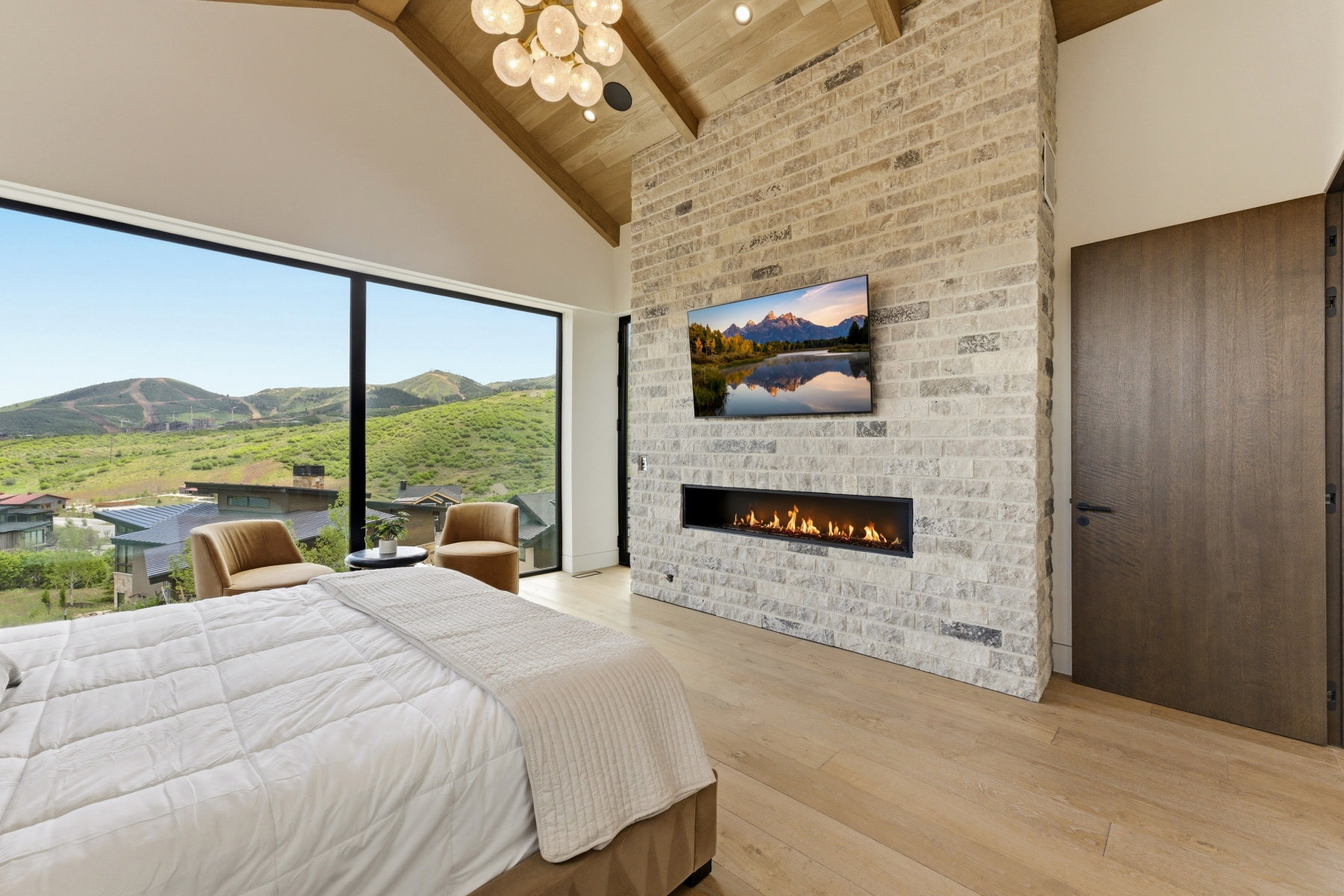 Expansive floor-to-ceiling window showcasing mountain scenery
