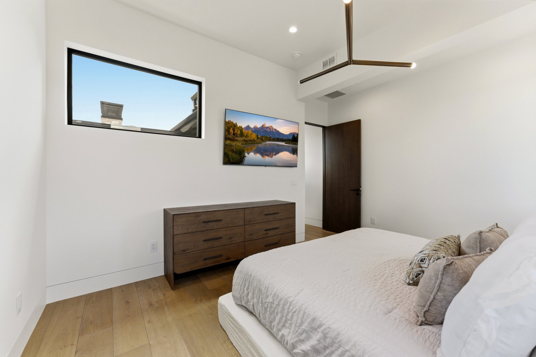 Bedroom featuring light wood-finish flooring and a white color palette