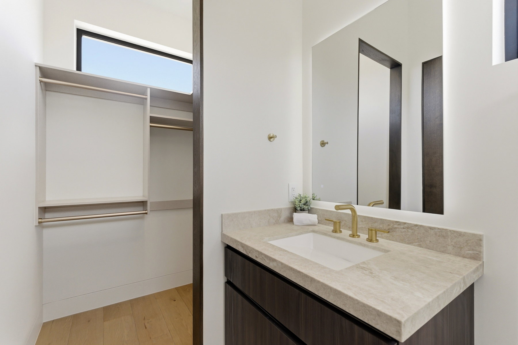 Custom closet organization system with blonde wood-finish flooring