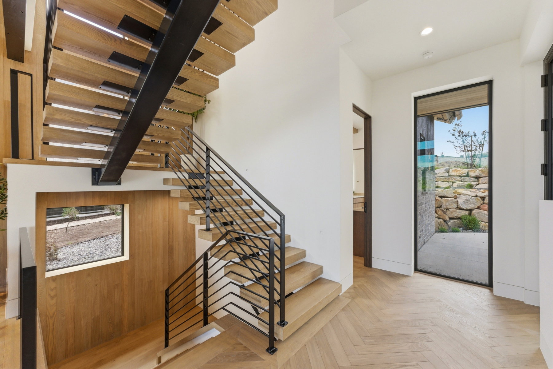 Floating staircase featuring wood treads and black metal railing