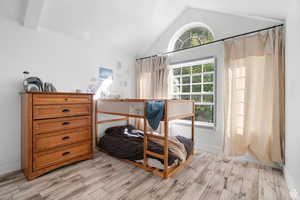 Bedroom featuring wood tiled floors and baseboards