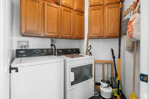Laundry room with cabinet space and washing machine and dryer