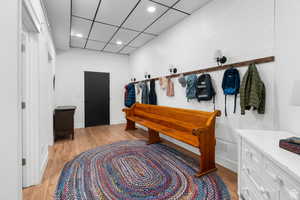 Mudroom with light wood-type flooring, recessed lighting, and a paneled ceiling