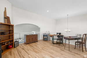 Family room/den/office featuring light wood-style floors and suspended lighting