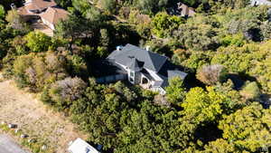 Aerial view of property, RV parking and surrounding area with a tree filled landscape