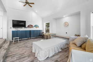 Family room featuring wood tiled floors, vaulted ceiling, recessed lighting, and a ceiling fan