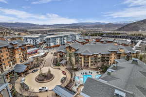 Drone / aerial view of mountains and apartment complex / building