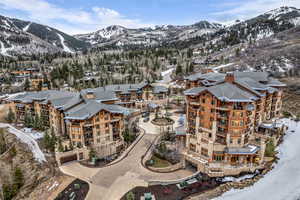Snowy aerial view featuring a mountain view
