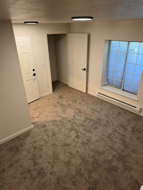 Room featuring neutral-toned carpeting and light-colored walls
