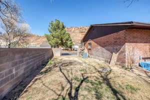 Fenced backyard with a mountain view