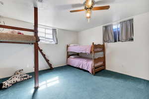 Bedroom with a textured ceiling, ceiling fan, and carpet flooring