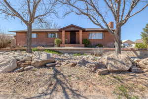 Ranch-style house with brick siding and a chimney