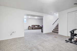 Workout area with light colored carpet and baseboards