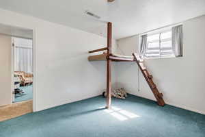 Unfurnished bedroom with carpet floors and a textured ceiling