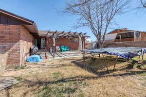 Fenced backyard featuring a pergola, a storage shed, a patio area, and a covered pool