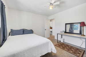 Bedroom featuring light carpet and a ceiling fan