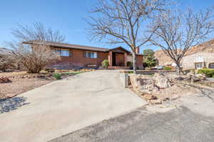 View of front facade with brick siding and a chimney