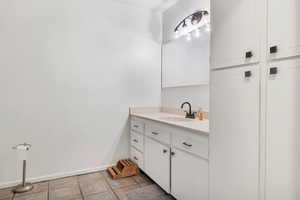 Bathroom with vanity and light tile patterned floors