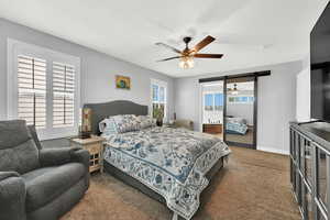 Bedroom with dark carpet and ceiling fan